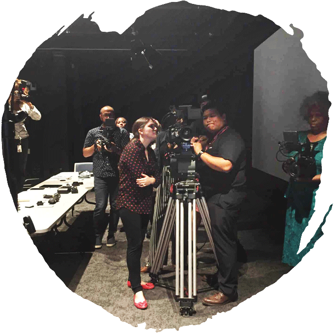 Photo of videographers behind camera in workshop setting